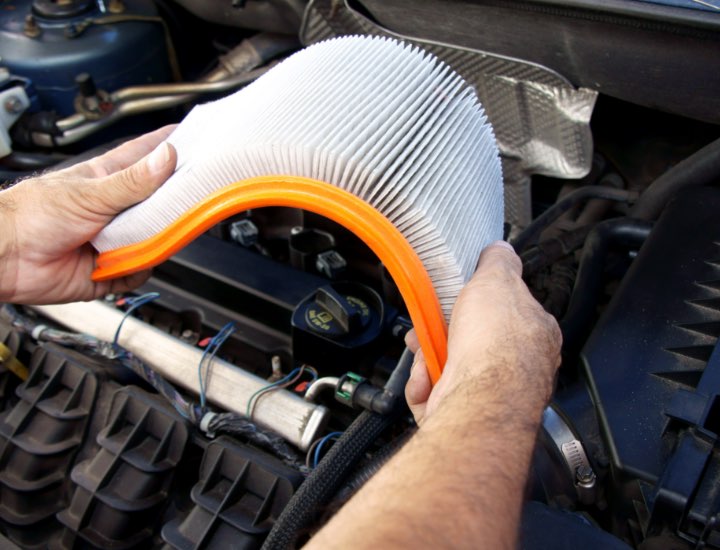 Technician Flexing Orange Air Filter